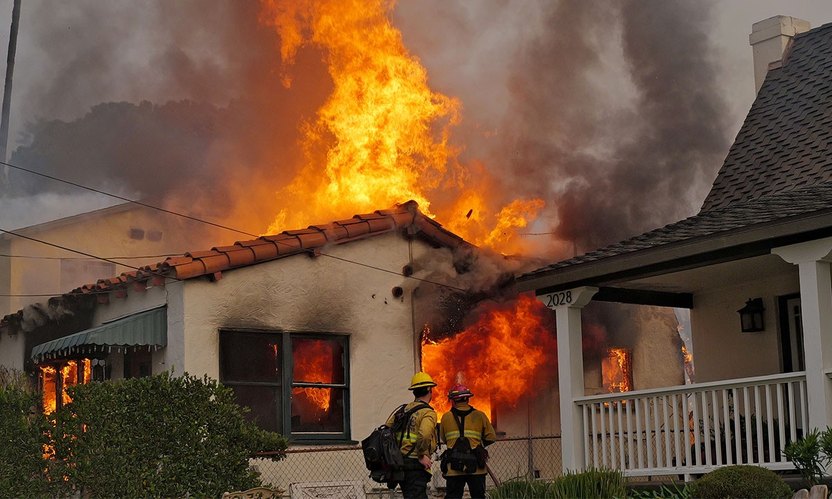 A house is on fire from the Eaton Fire in the Altadena neighborhood on January 08, 2025 in PASADENA, CALIFORNIA. A spokesperson for the Los Angeles County Sheriff's Department said the death toll has risen, confirming three more people have died. Additionally, an undetermined amount of homes and businesses have been destroyed. (Photo by Nick Ut/Getty Images)