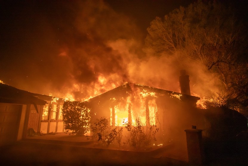 LOS ANGELES, CALIFORNIA - JANUARY 8: Flames from the Palisades Fire burns a home during a powerful windstorm on January 8, 2025 in the Pacific Palisades neighborhood of Los Angeles, California. The fast-moving wildfire is threatening homes in the coastal neighborhood amid intense Santa Ana Winds and dry conditions in Southern California. (Photo by Apu Gomes/Getty Images)