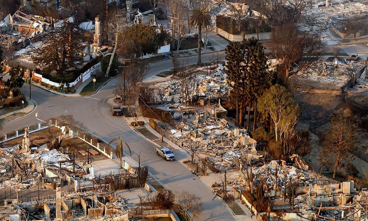 aerial view taken from a helicopter, burned homes are seen from above during the Palisades fire in the Pacific Palisades neighborhood of Los Angeles, California