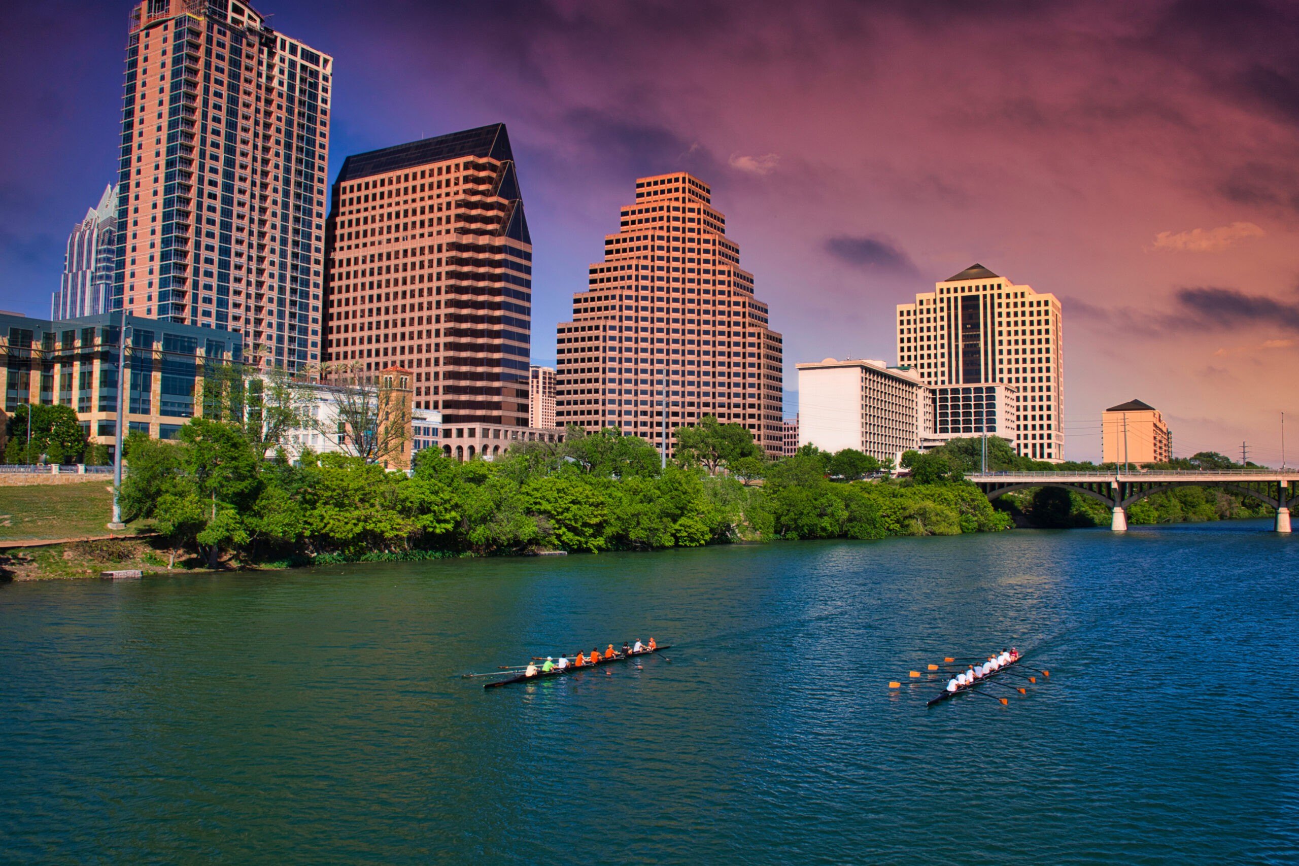 View of the cityscape above Lady Bird Lake, Austin, Texas, April 13, 2009. On the lake are a pair of rowing teams in their boats. (Photo by Ed Lallo/Getty Images)