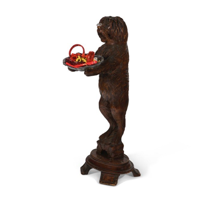 This old world terrier stand with a tray full of Apfel's iconic jewelry is sure to bring a smile.