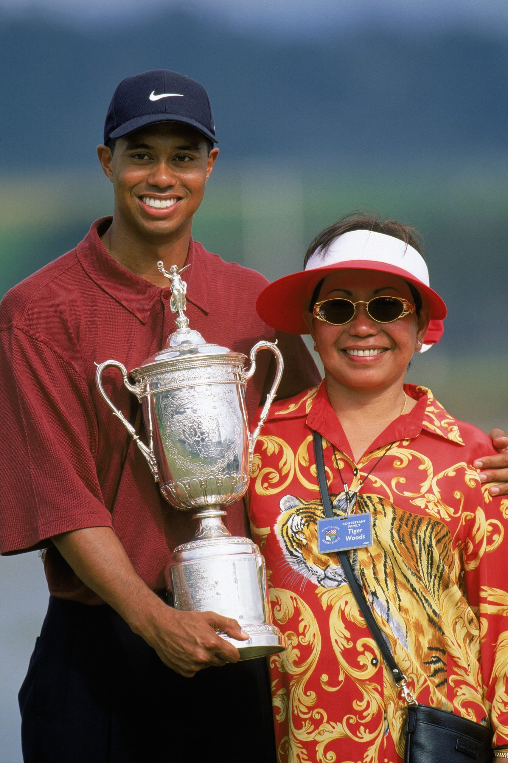 PEBBLE BEACH, CA - JUNE 18: Tiger Woods holds the trophy as he poses with his mother Kultida Woods after winning the 100th US Open at the Pebble Beach Golf Links on June 18, 2000 in Pebble Beach, California. (Photo by Jamie Squire/Getty Images)