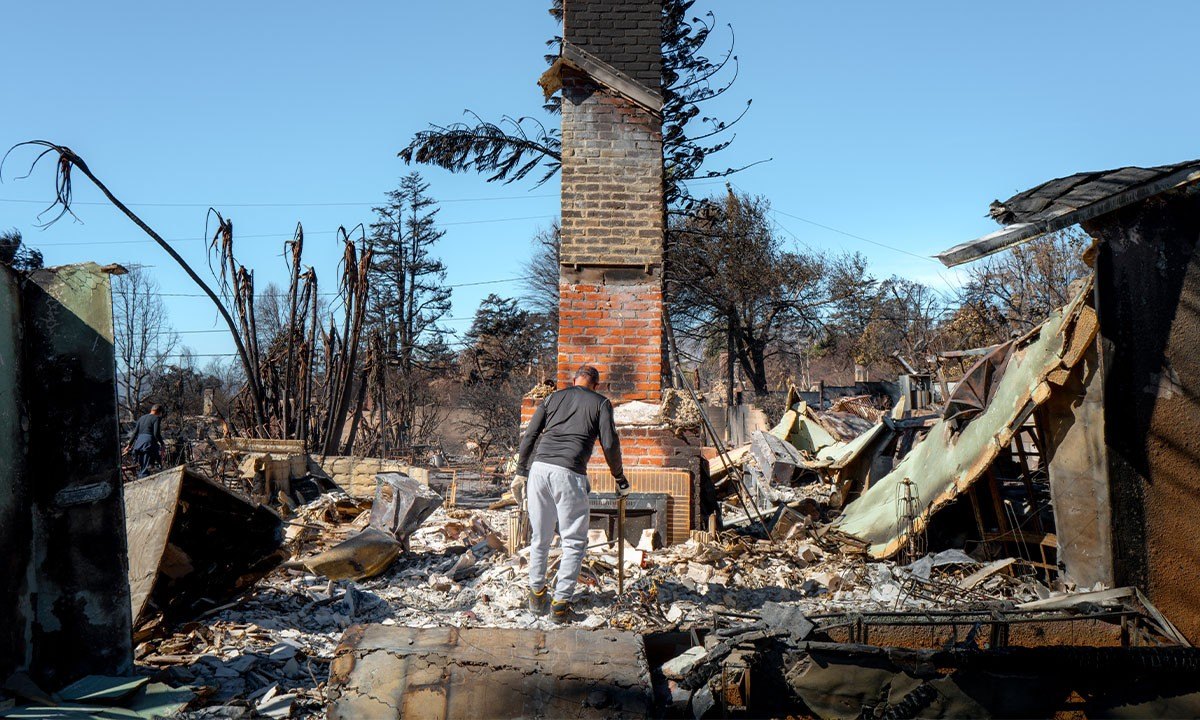 Steve Hudson sifts through what remains of his living room on January 21, 2025 in Altadena, California.