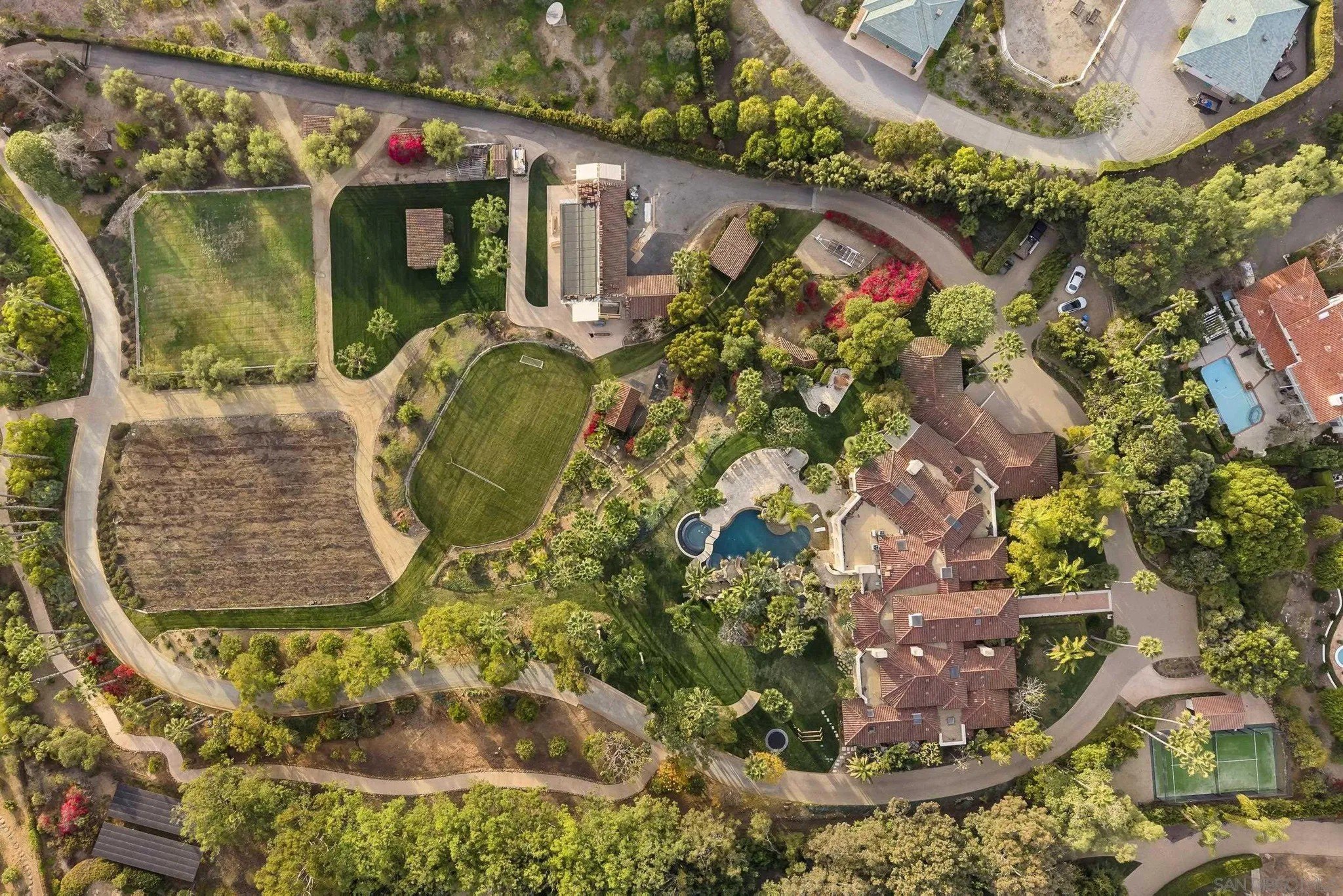 The overhead view shows the six acre compound includes a pool, equestrian facilities, a vineyard, orange grove and guest house. 