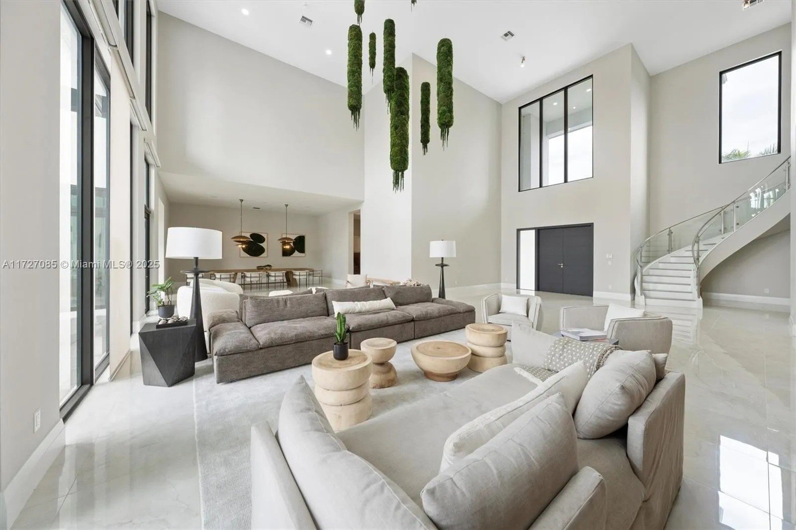 huge room with moss chandelier and neutral furniture