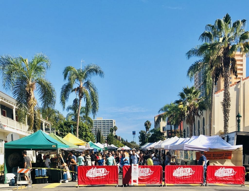 San Diego Farmers Market in Little Italy - Vendor stalls on closed off street under palm trees