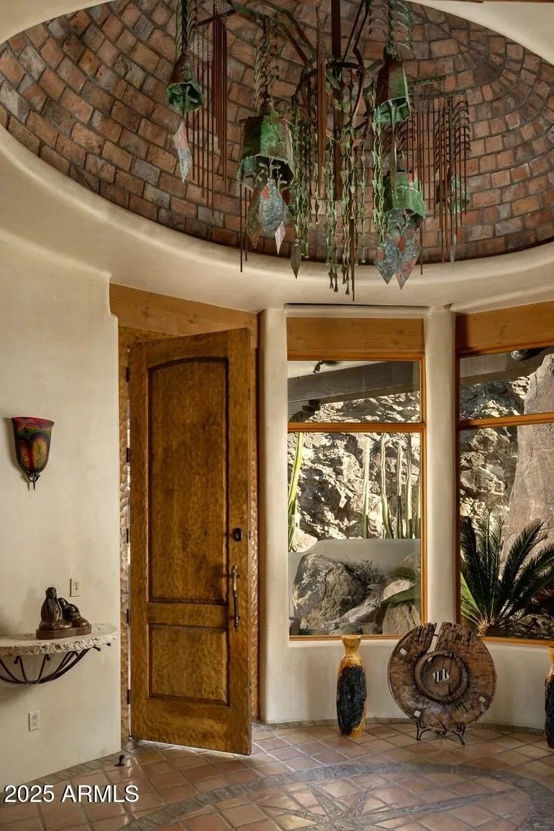 The foyer also features a chandelier ornamented with Soleri bells that are worth thousands.