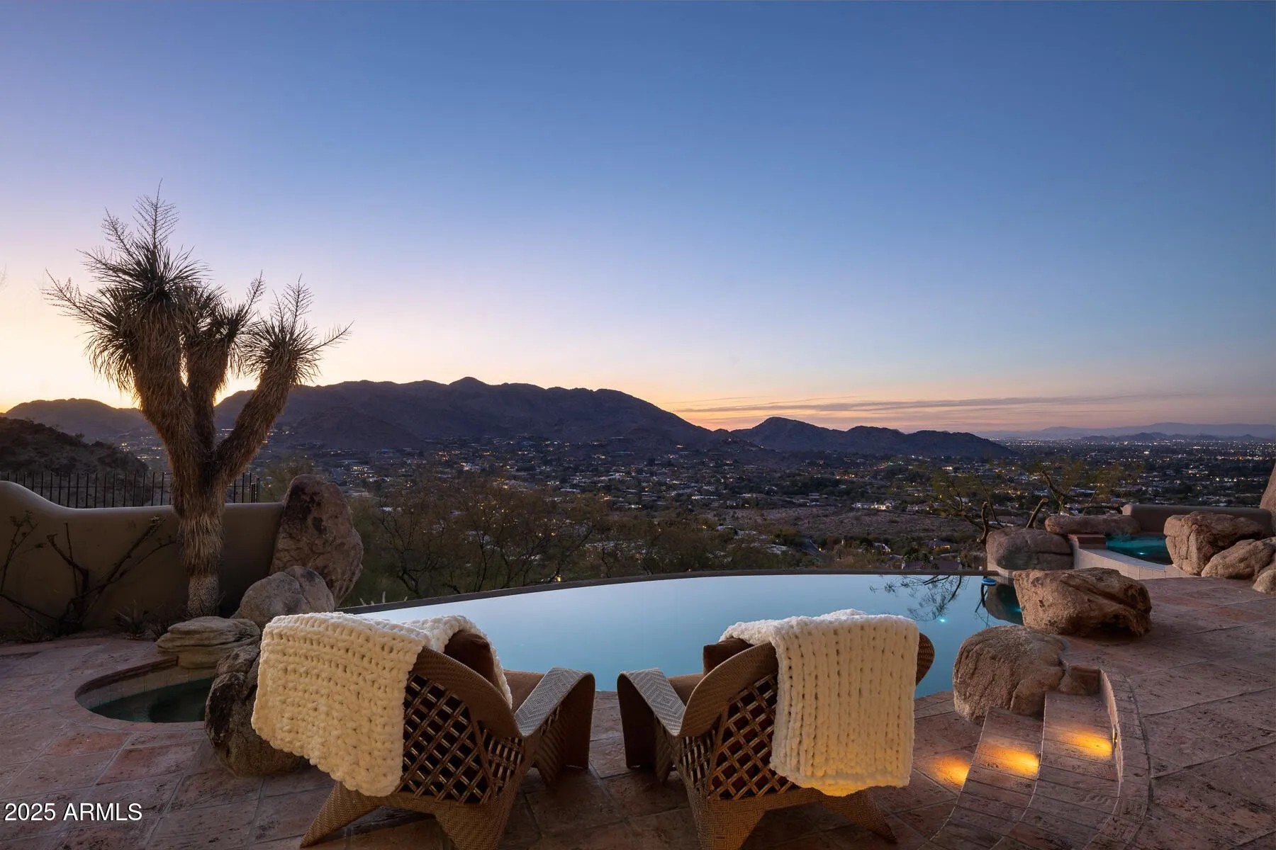 The home features forever unobstructed views of sunsets and the entire valley below.