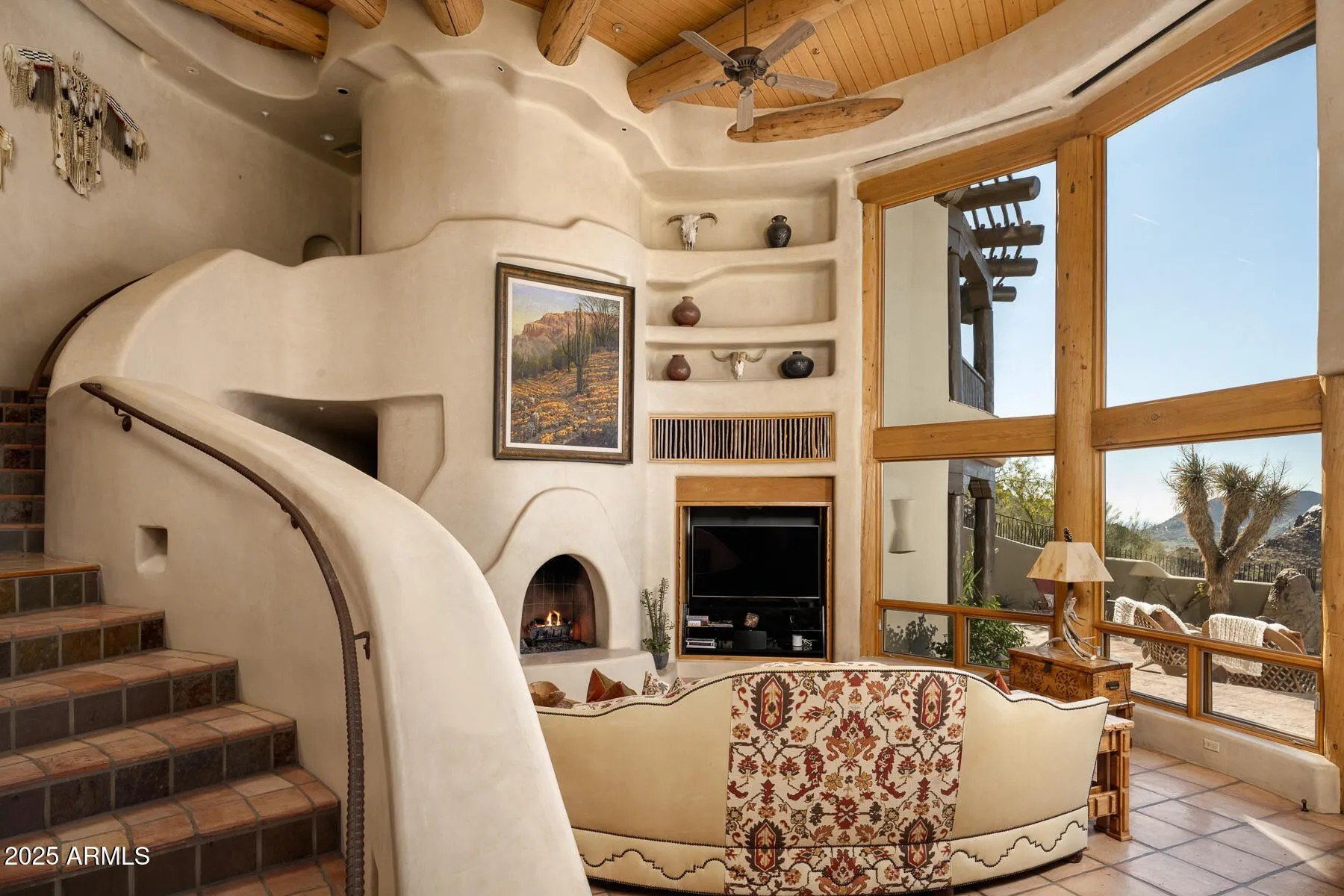 The home is inspired by the "Organic Pueblo Philosophy, in which traditional Southwestern craftsmanship melds with fluid, nature-inspired forms.