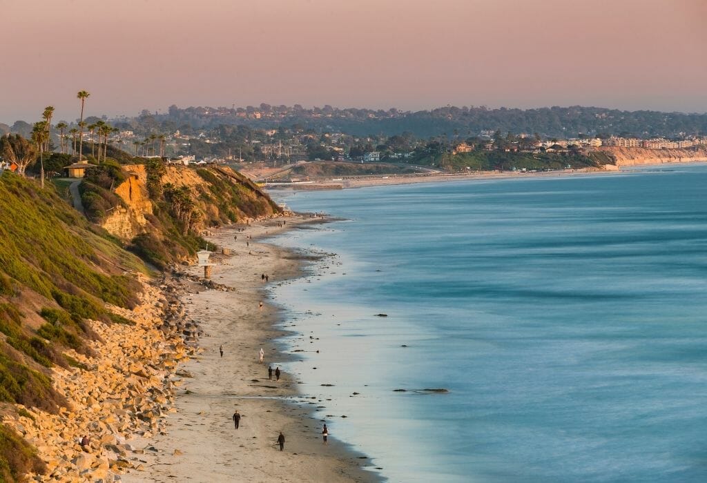 view over the coast line at San elijo state beach with ocean on the right and beach and bluffs on the left