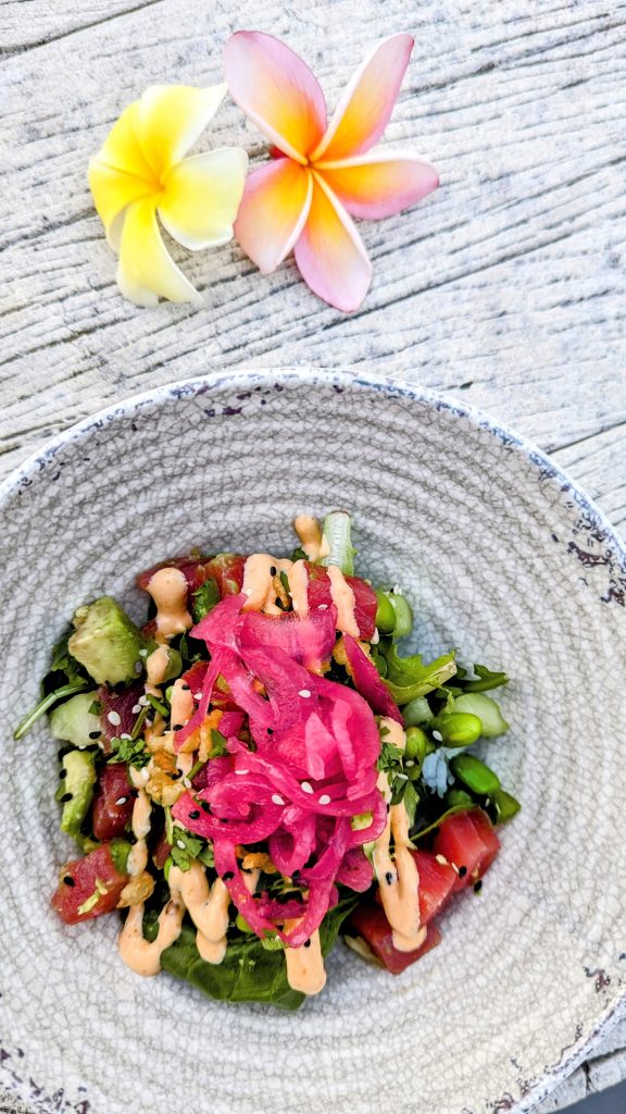 poke bowl on table with 2 flowers at 5 o'clock somewhere bar at Margaritaville Hotel San Diego