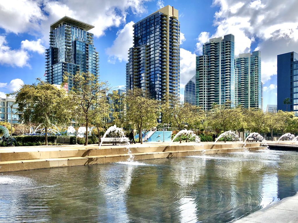 Fountain in the foreground with Highrise apartment buildings in the background at Waterfront Park San Diego Free things to do