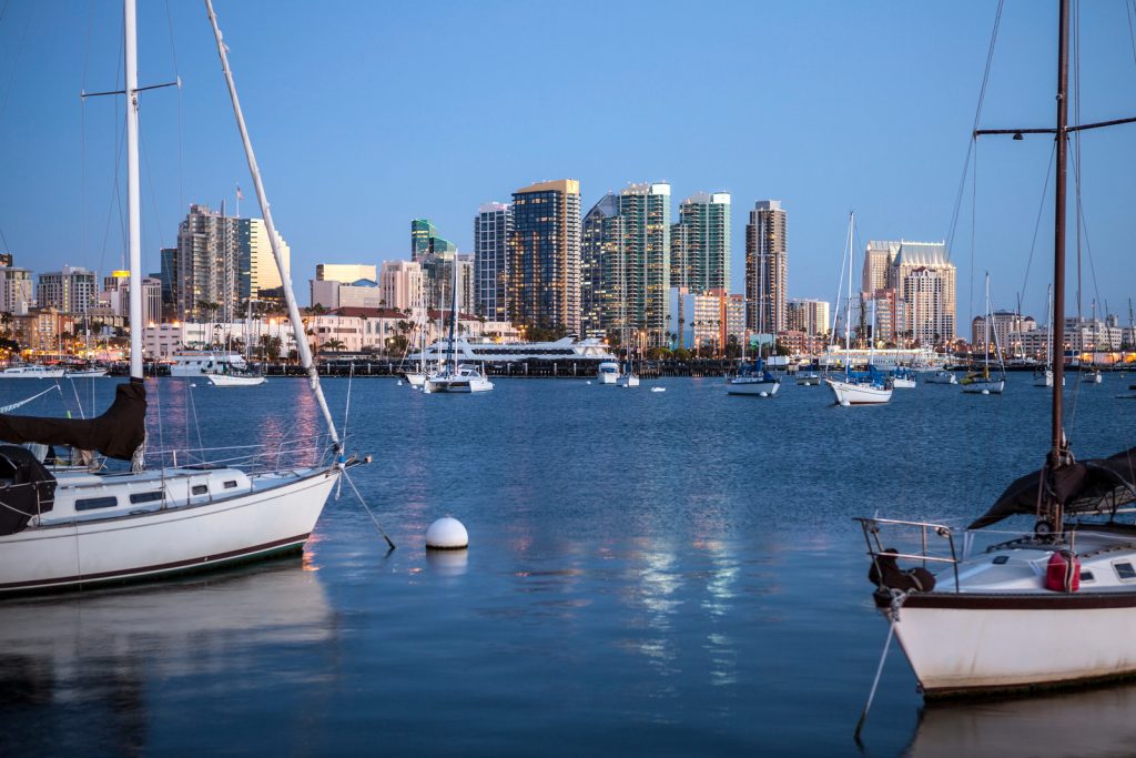 San Diego downtown skyline at night with boat in harbor.