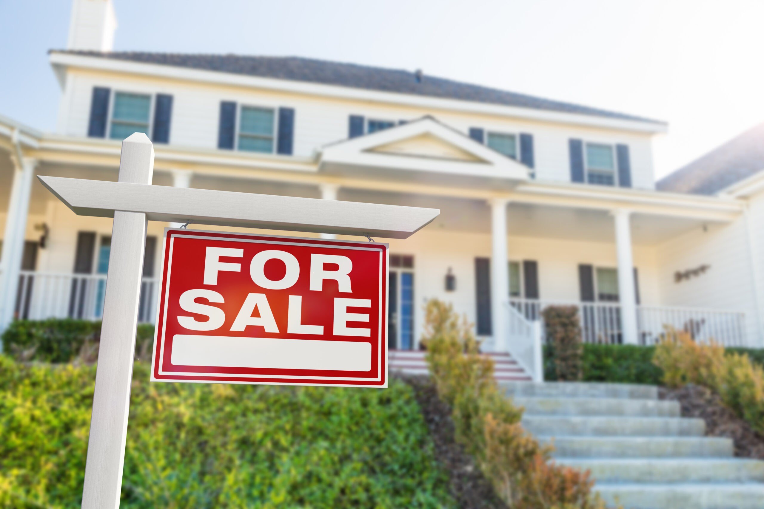 For Sale Real Estate Sign in Front of New House.