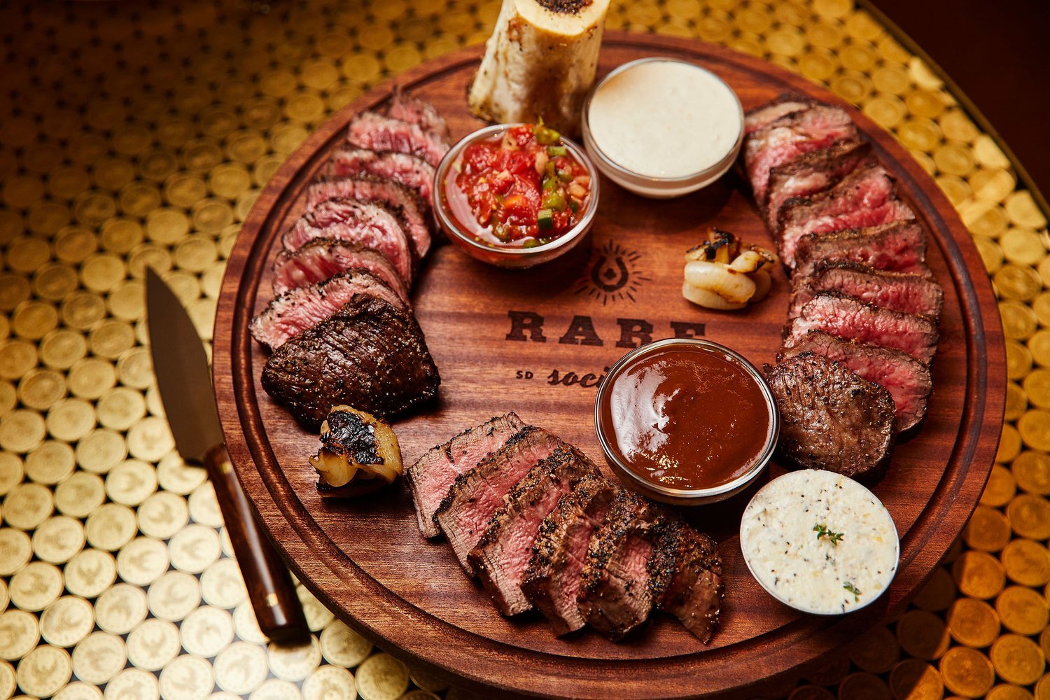 Best San Diego steak restaurants featuring a cut of meat on a cutting board from Rare Society in University Heights