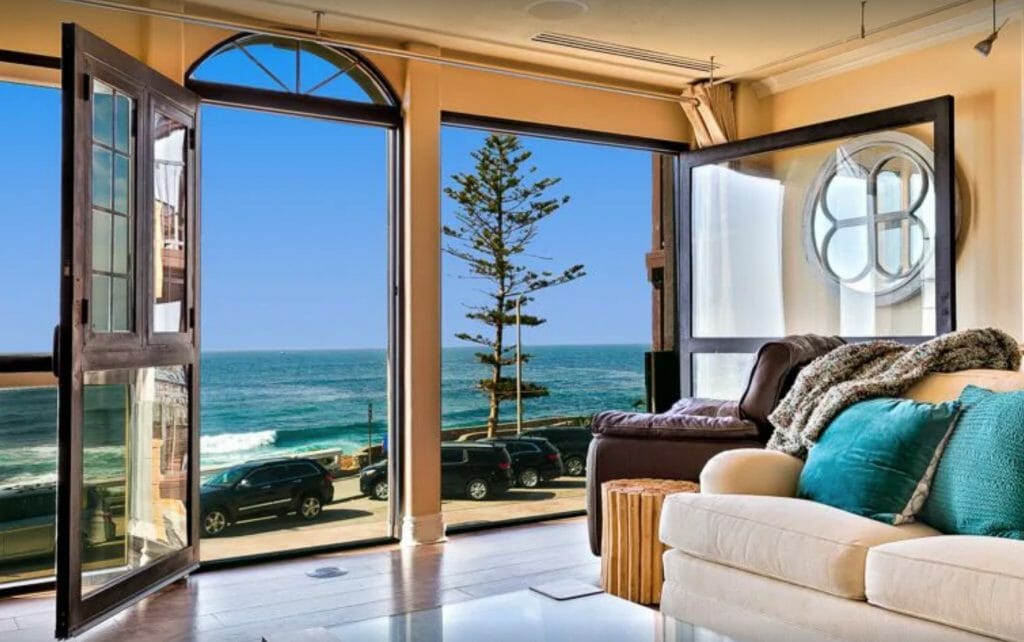 Elegant living room with windows overlooking the ocean - luxury La Jolla vacation rentals