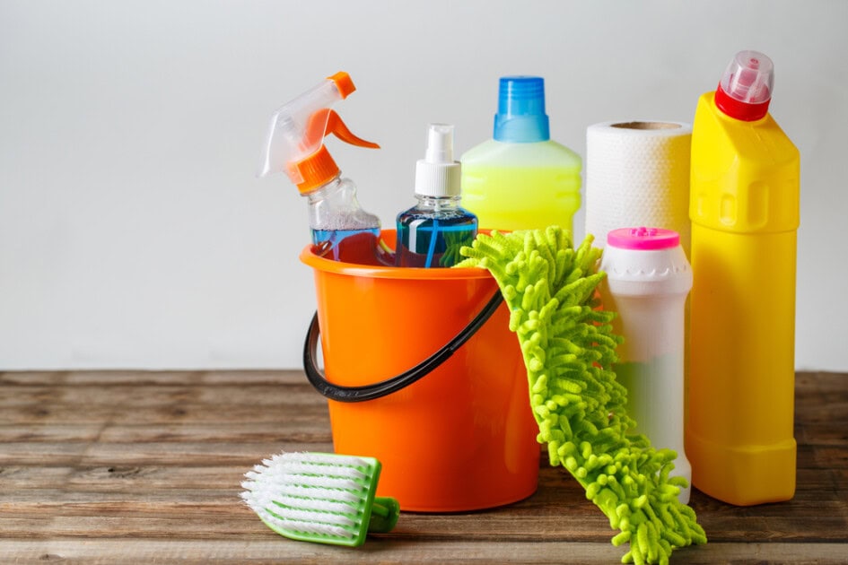 Cleaning supplies sitting in a bucket