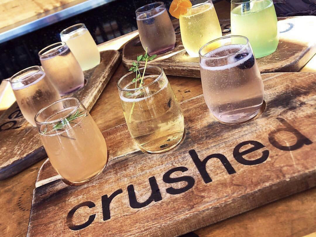 Flights of different cocktails on wood boards