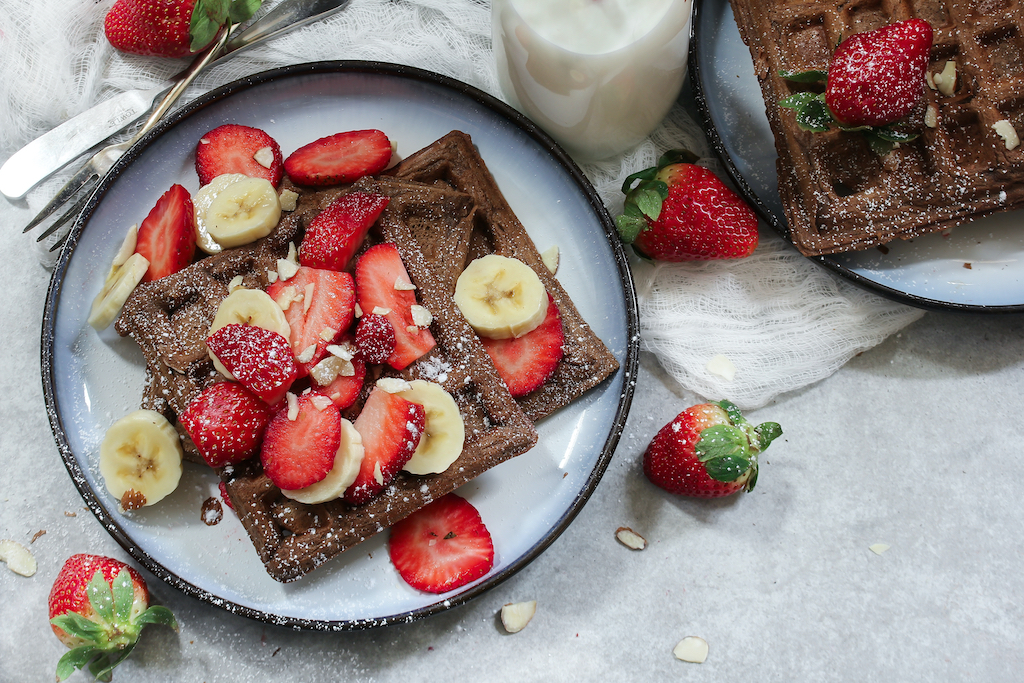 Homemade Chocolate Waffles topped with fresh berries and banana