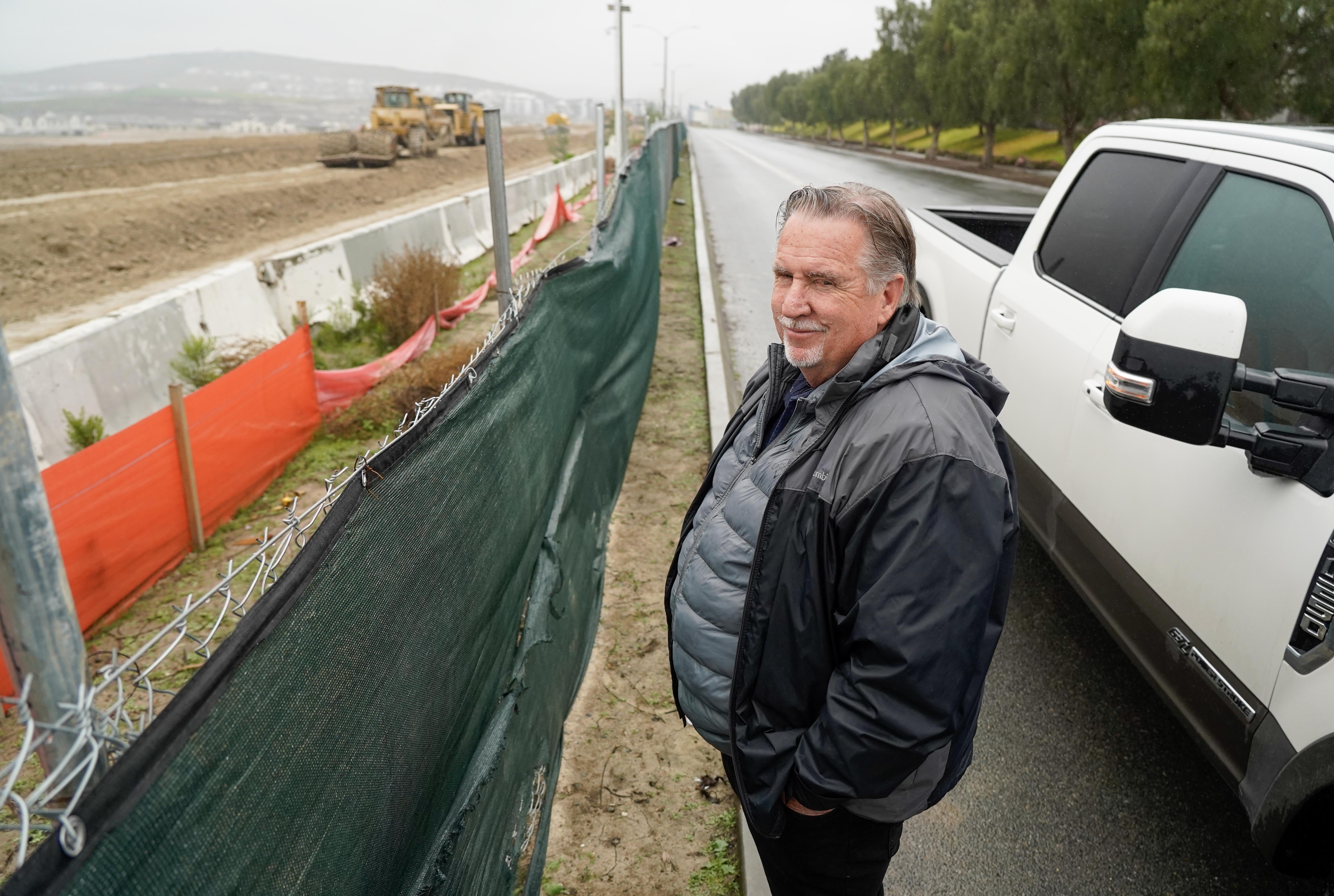 Kent Aden, President of HomeFed Communities, looking over construction in...