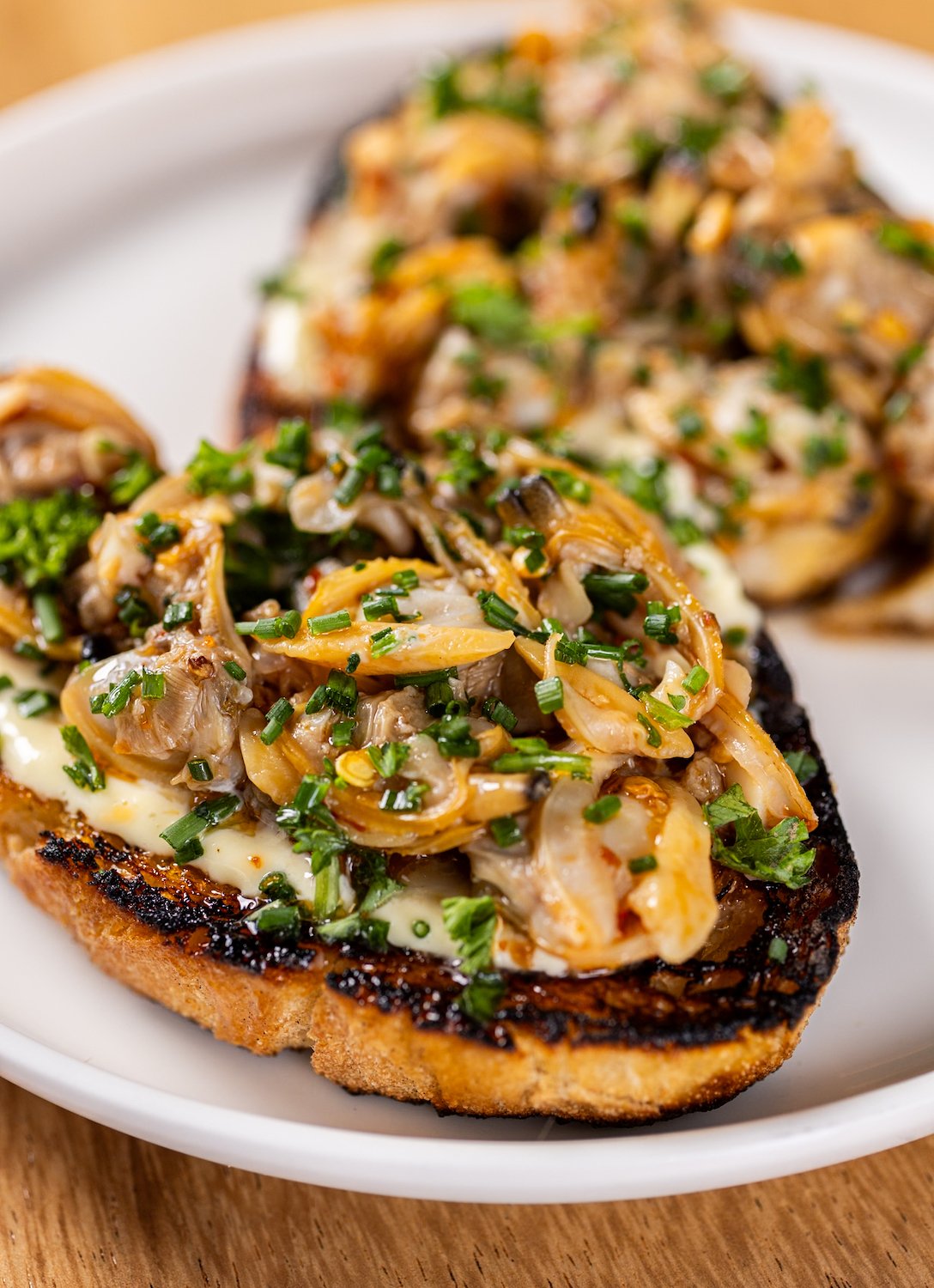 Marinated clam crostini from San Diego Mediterranean restaurant Boujie Mana in Serra Mesa