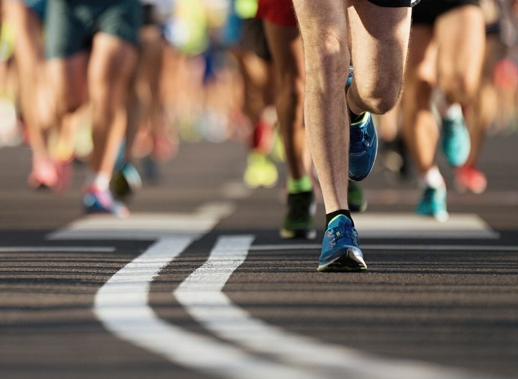 Marathon running race feet closup from the road