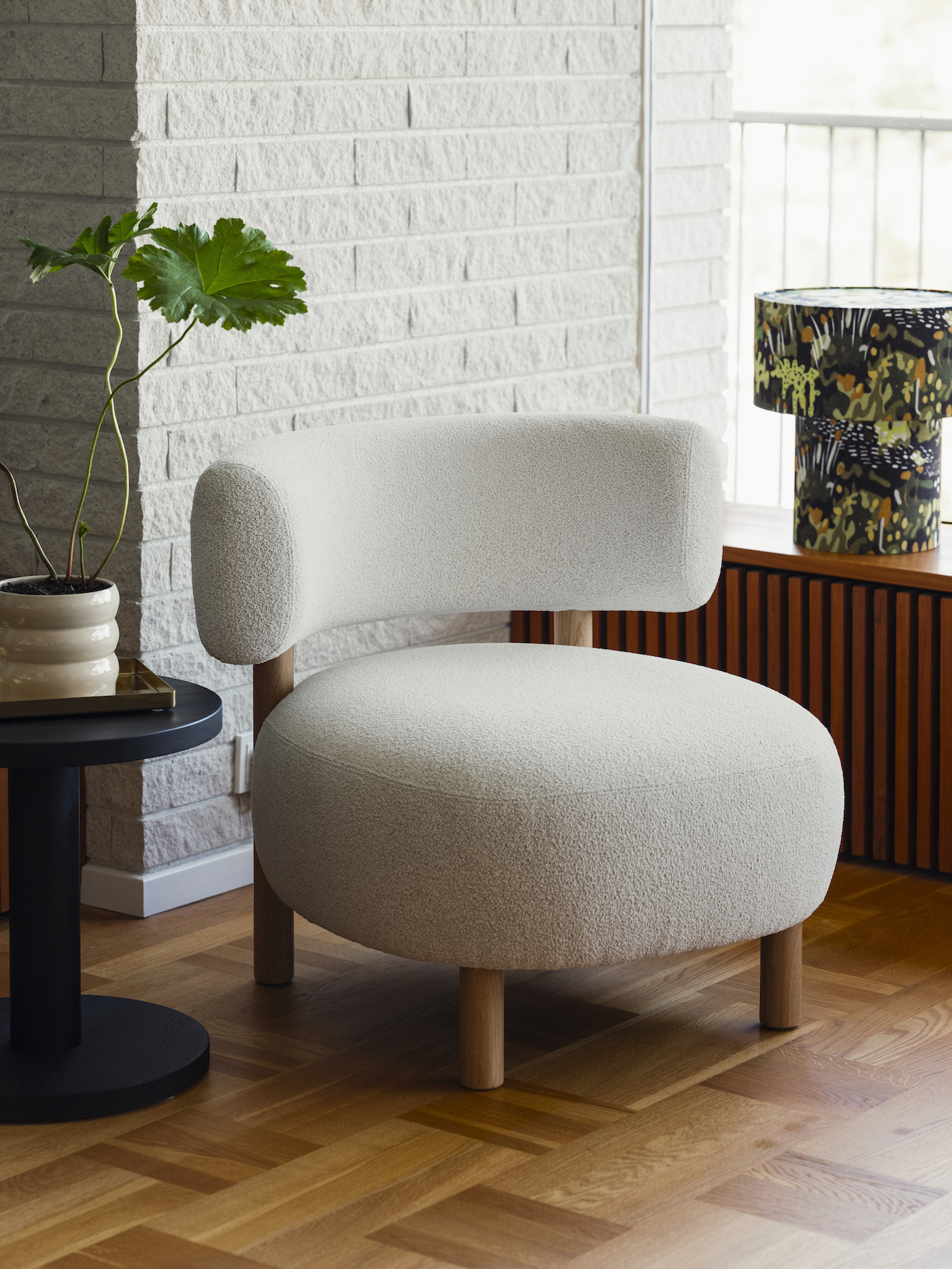 A white armchair with a curved backrest