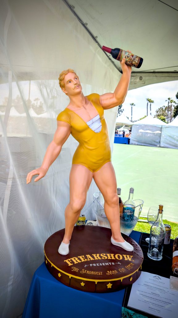 Vintage statue of man holding wine bottle