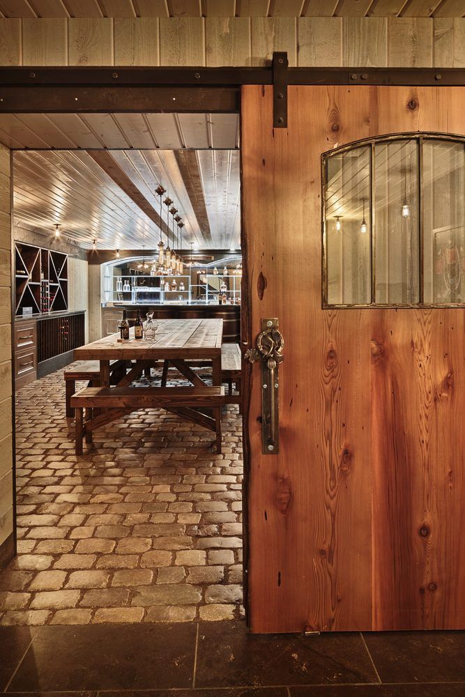 Reclaimed materials and a rustic but luxurious style distinguish this wine cellar.