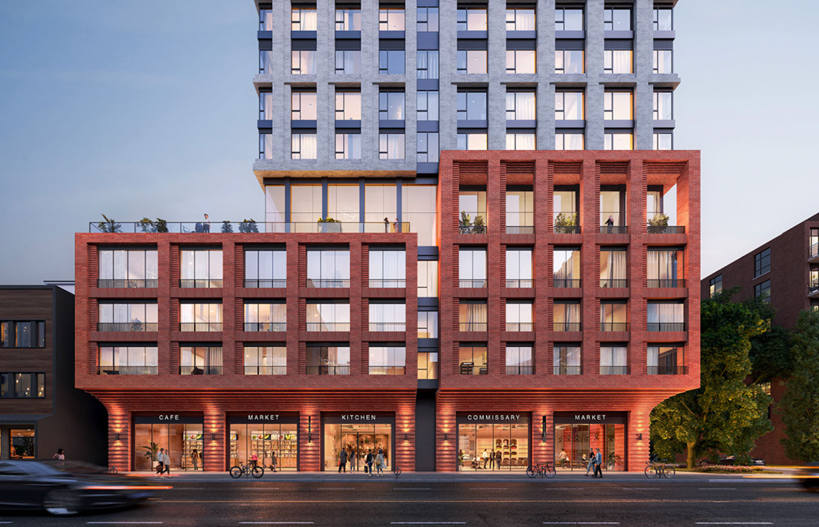 A modern mixed-use building with a brick facade at street level, featuring shops and cafes, and large windows above, with people and cyclists on the sidewalk.