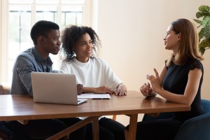 Couple talking over their recent home purchase with an agent