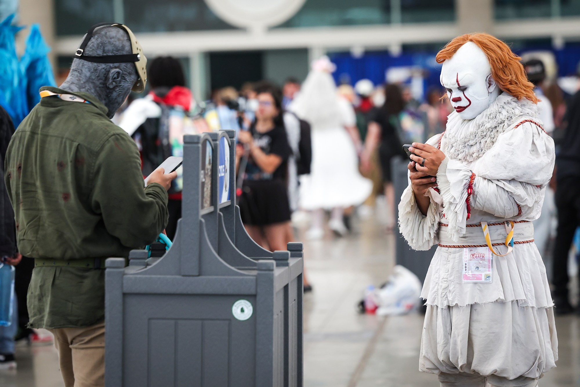Cosplayers check their phones during day 3 of the 2025 Comic-Con International convention at the San Diego Convention Center on Saturday, July 26, 2025 in San Diego, CA. (Meg McLaughlin / The San Diego Union-Tribune)