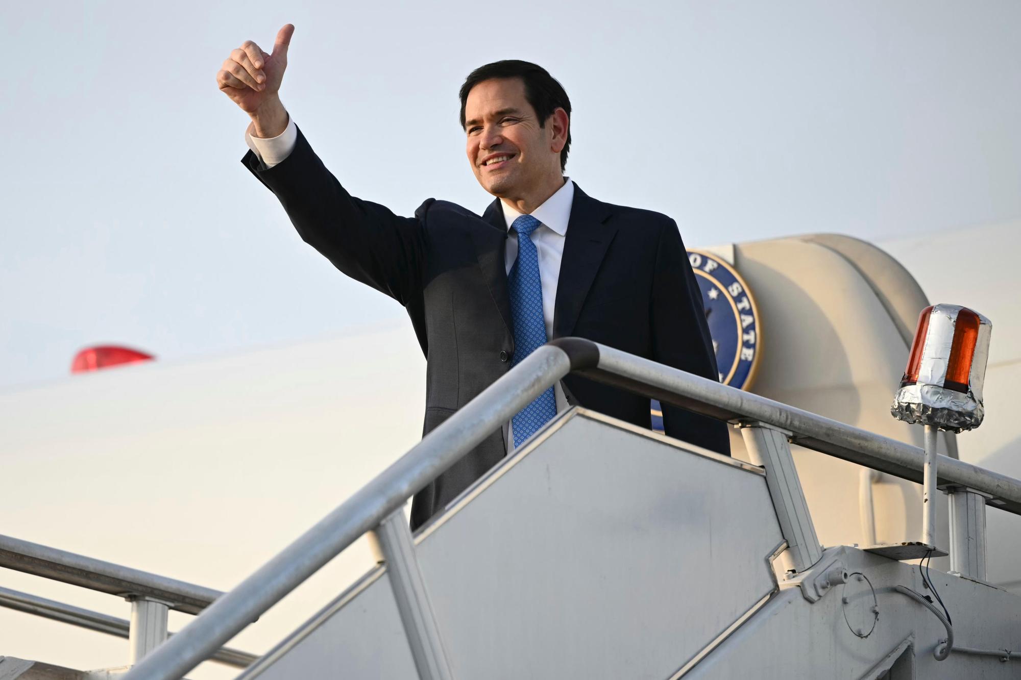 US Secretary of State Marco Rubio gestures as he boards his flight before departing from Subang Air Base, on the outskirts of Kuala Lumpur, on Friday, July 11, 2025, after attending the 58th ASEAN Foreign Ministers' meeting. (Mandel Ngan/Pool Photo via AP)