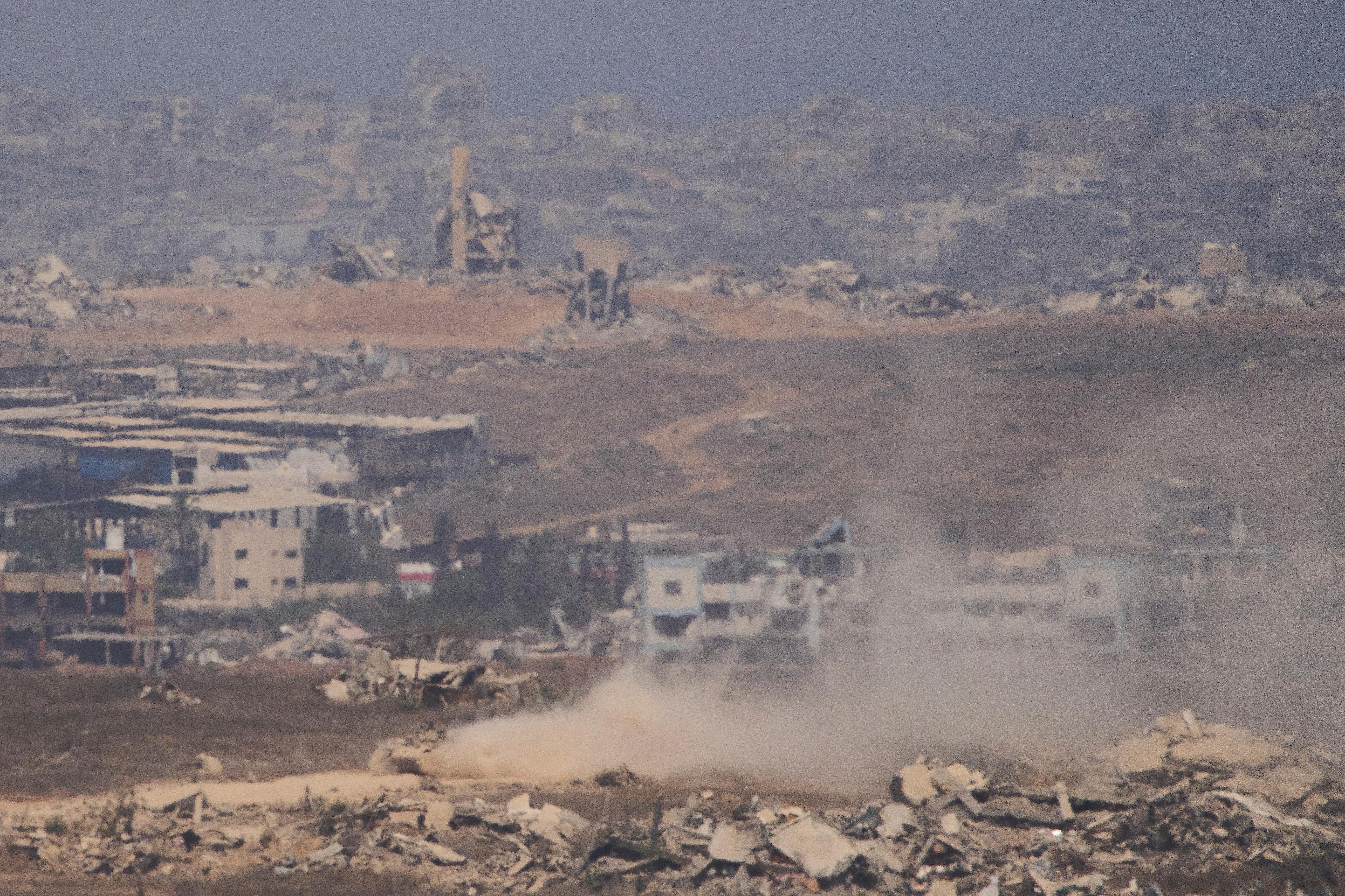 Israeli soldiers drive on their armored personnel carrier inside the...