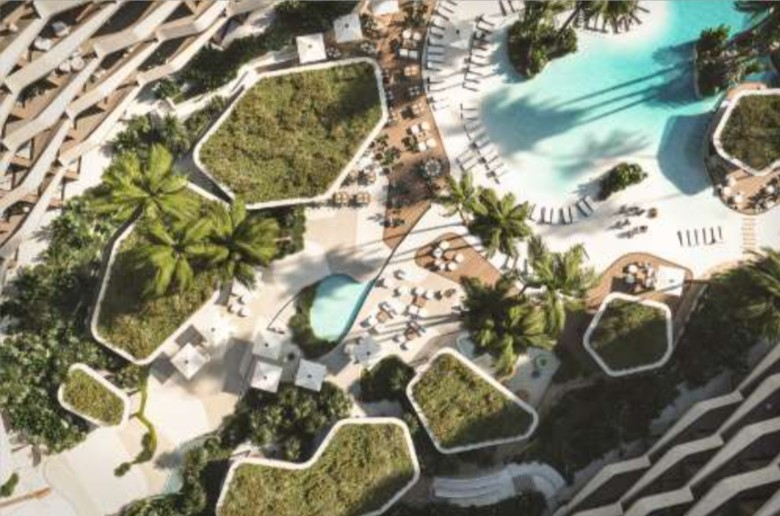 Aerial view of a modern resort with irregular-shaped green spaces, a large swimming pool, lounge chairs, and palm trees.