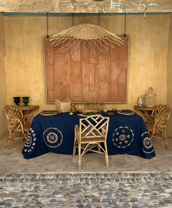 atelier vime shop courtyard table with wayne pate ceramic mural. 7