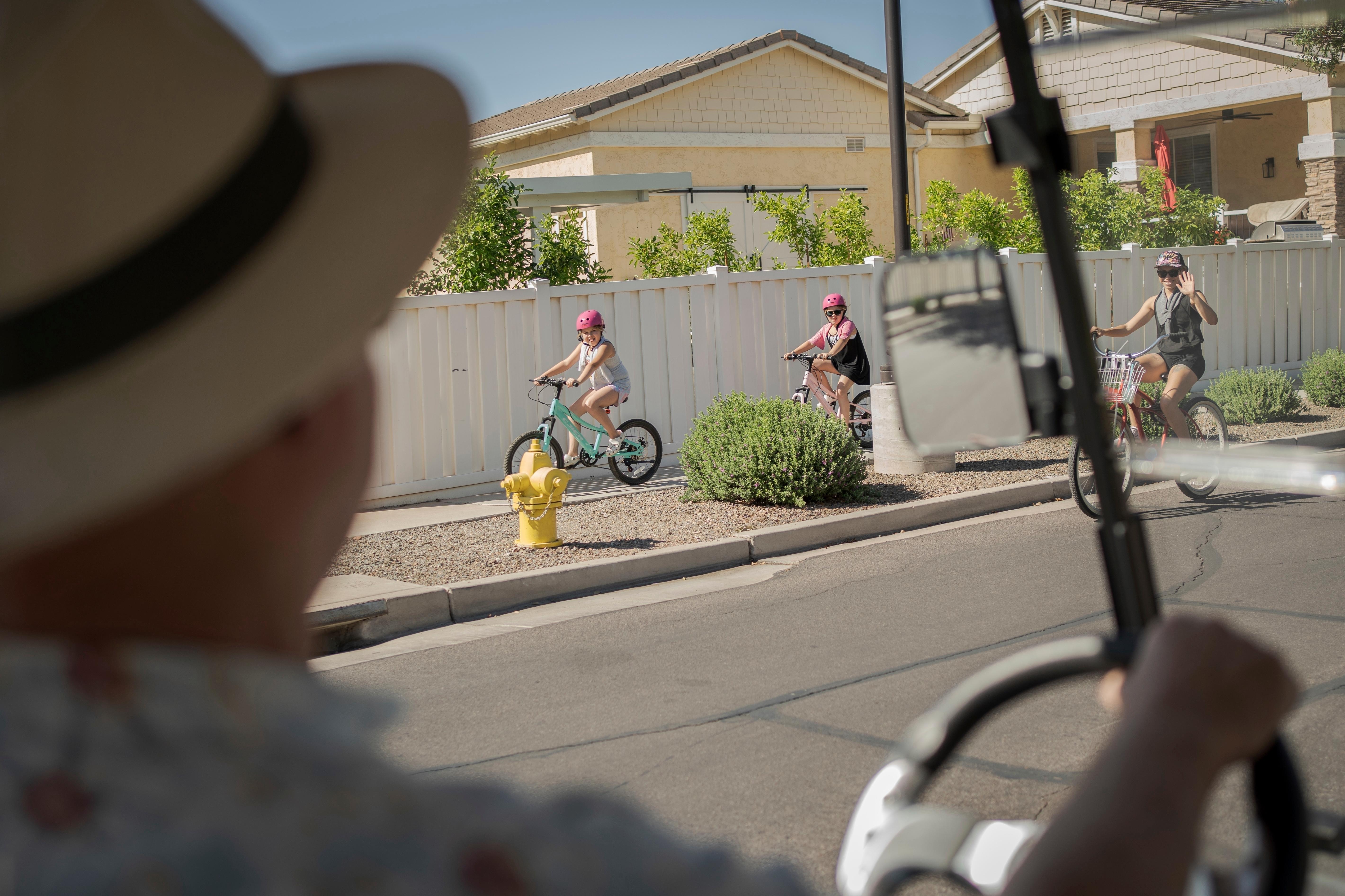 Residents greet Joe Johnston, founder of Agritopia, a community nestled...