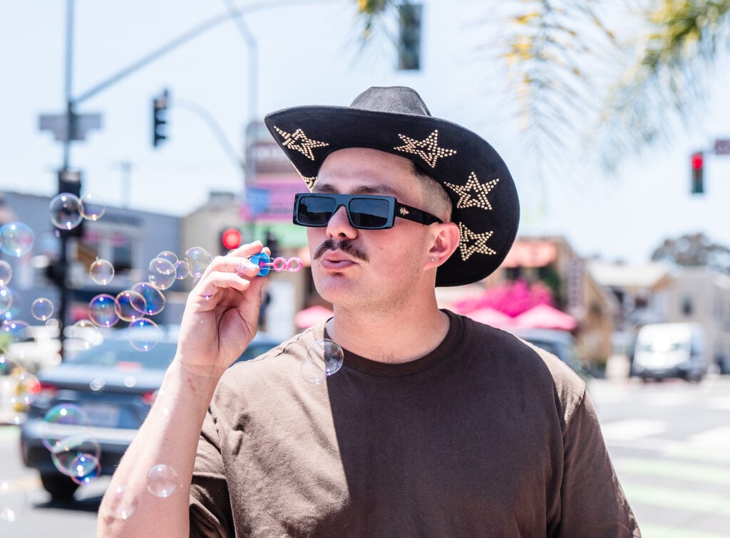 Man blowing bubbles in Hillcrest neighborhood of San Diego 