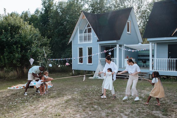 Family Playing Tug of War in their backyard.