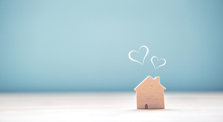 Small wooden house block with 2 doodled hearts