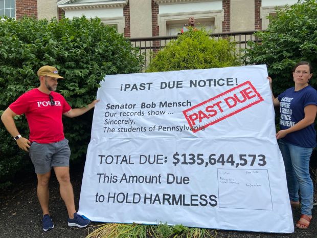 POWER Interfaith regional director Will Fuller and Laura Johnson, co-founder of Pennsylvanians for Fair Funding, with a sign at a fair funding rally held at Pottstown Middle School.(MediaNews Group File Photo)