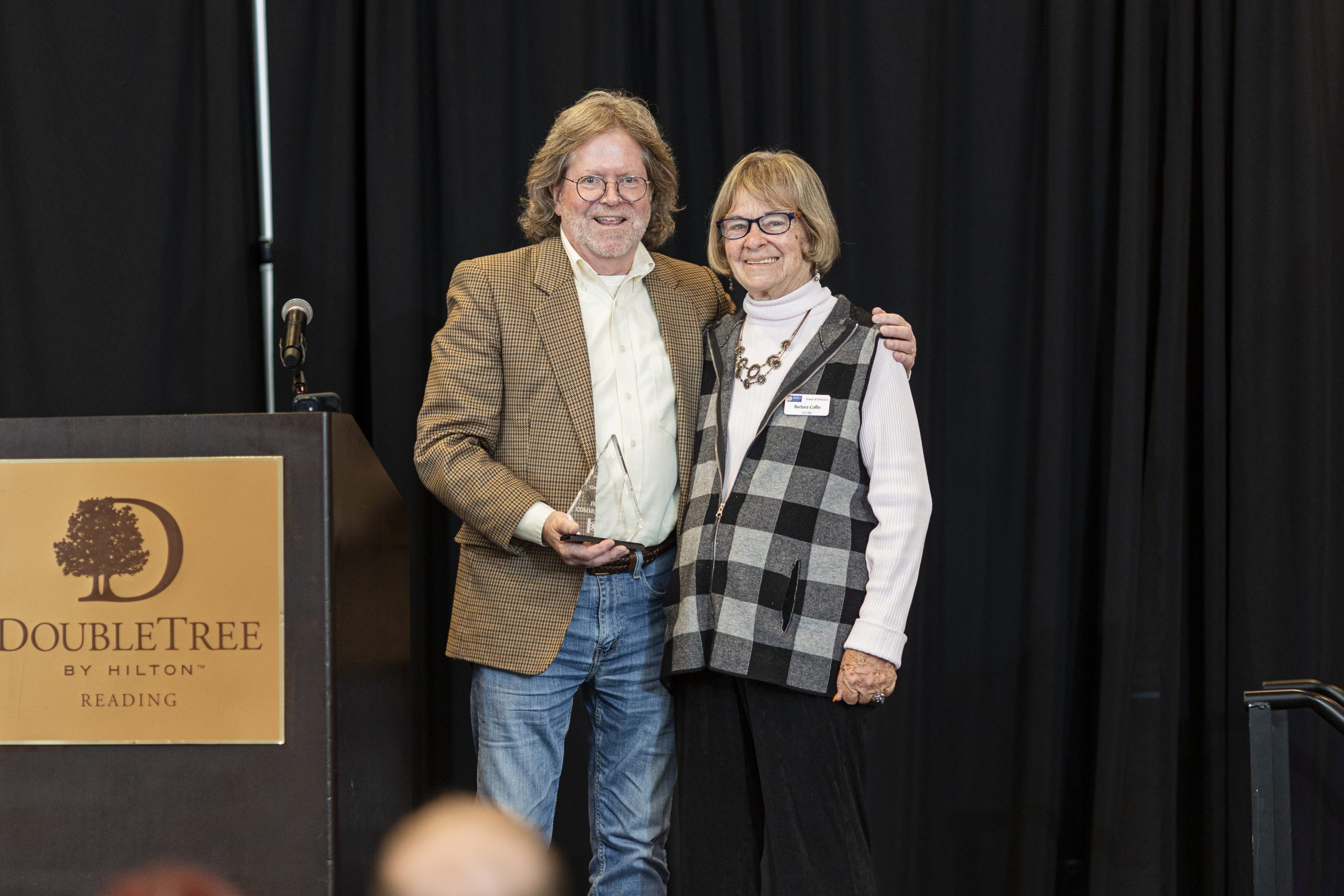 Friend Inc. Executive Director Jim Reece, left, accepts the Community...