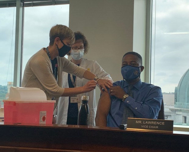 Montgomery County Commissioners' Vice Chairman Ken Lawrence Jr. receives a flu shot on Thursday during a Montgomery County Board of Commissioners meeting. Photo courtesy Kelly Cofrancisco