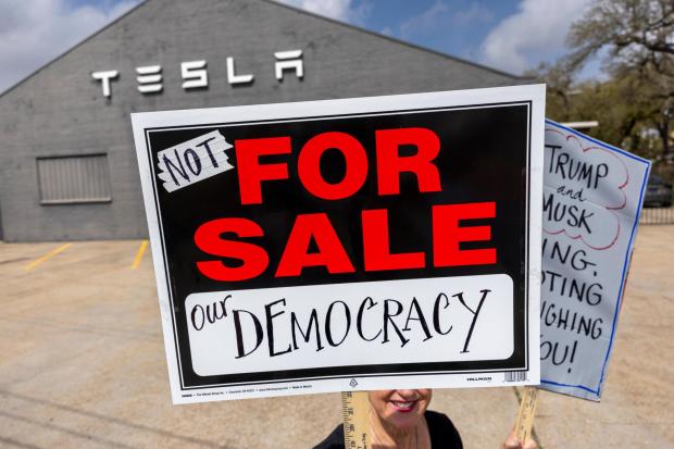 Protesters outside a Tesla Service Center on Tchoupitoulas Street in New Orleans