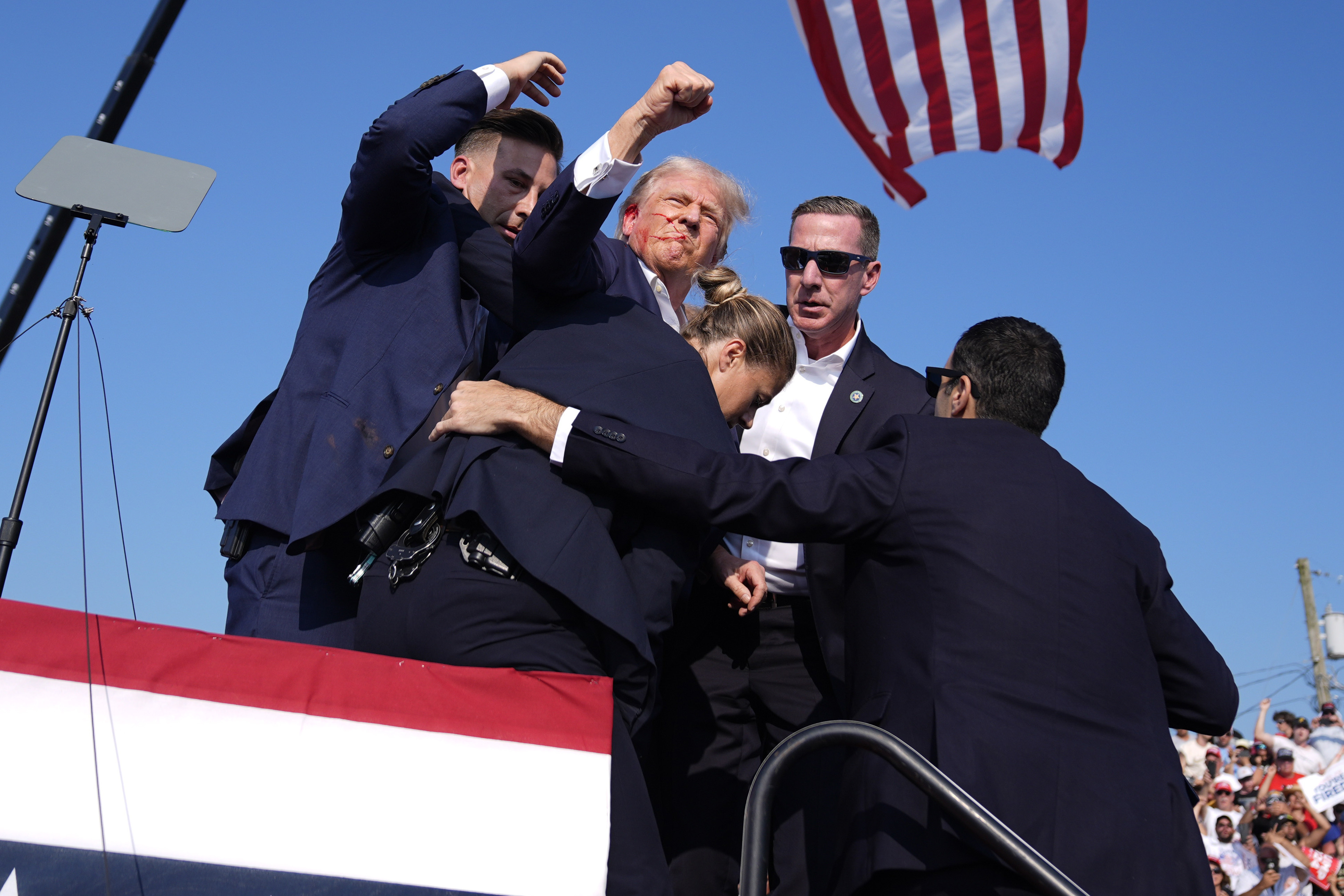 Republican presidential candidate former President Donald Trump is surrounded by...