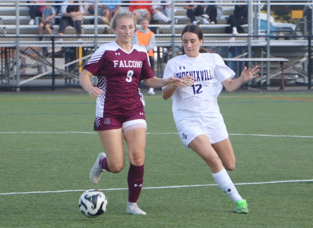 Pottsgrove's Abigail Baker (9) and Phoenixville's Emma Ward (12) fight for possession of the ball near midfield at Pottsgrove High School on Sept. 20. (Evan Wheaton - MediaNews Group)