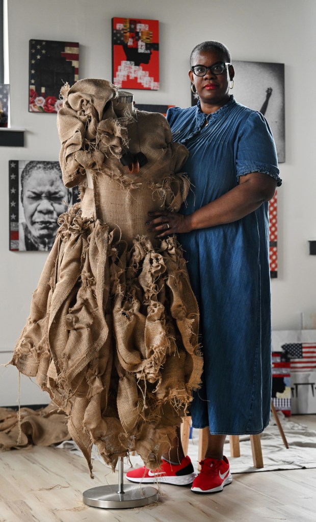 Chloé Duplessis stands next to a burlap dress that she is making for her upcoming show Sista Soldier in her studio at East Street School in Trinidad on September 11, 2023. (Photo by Helen H. Richardson/The Denver Post)