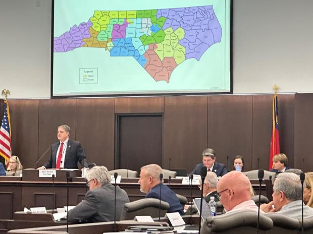 North Carolina state Sen. Warren Daniel, R-Burke (left and standing), presides over the Senate Committee on Elections while it considers legislation to redraw the state's U.S. House district map at the Legislative Office Building in Raleigh N.C., Monday, Oct. 20, 2025. (AP Photo/Gary D. Robertson)