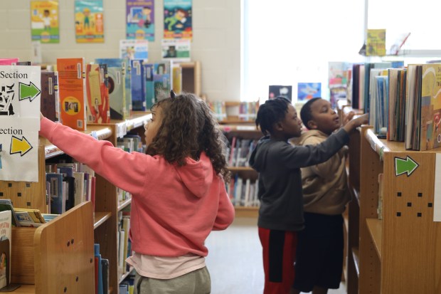 Barth Elementary School Fourth Graders choose from among the library's new books. (Photo courtesy of Anthony Santiago)
