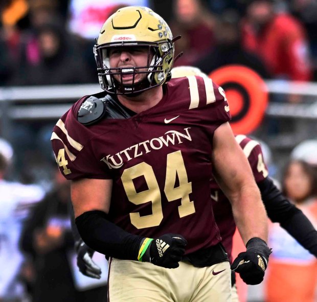 Kutztown University's Brayden Pohlman celebrates his fourth and 2 stuff of IUP's Tavion Banks that sealed the Golden Bears' victory in their 28-23 win over the Indiana University of Pennsylvania in the Pennsylvania State Athletic Conference championship at Andre Reed Stadium on Saturday, Nov. 15, 2025. (BILL UHRICH/READING EAGLE)